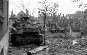 Battle of Aachen: M4 Sherman tank commander scopes out enemy targets, Aachen, October 1944