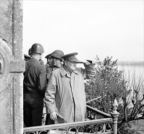 Churchill, U.S. generals watch vehicles cross Rhine, March 25, 1945
