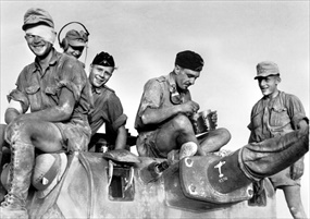 Operation Crusader: Afrika Korps soldiers pose atop a tank, 1941