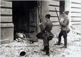 Soldiers stare past the bodies of Warsaw Jews