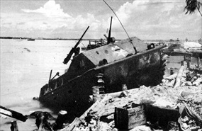 Disabled Landing Vehicle Tracked (LVT) at beach baracade on Red Beach 1, Battle of Tarawa
