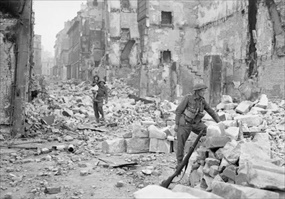 Capturing Caen: British soldier (center rear) carries small girl through devastation of Caen, July 10, 1944 Capturing Caen: British soldier (center rear) carries small girl through devastation of Caen, July 10, 1944