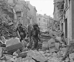 Capturing Caen: British soldiers trudge through rubble Capturing Caen: British soldiers trudge through rubble