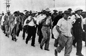 U.S. military and civilian prisoners march to Japanese transport ship, January 12, 1942 U.S. military and civilian prisoners march to Japanese transport ship, January 12, 1942